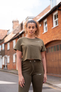 Women's olive crop t-shirt with small white logo.