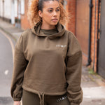 Women's olive oversized crop hoodie with tie waist and small white logo.