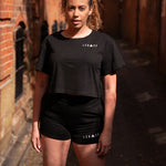 Women's black crop t-shirt with white logo.