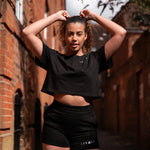 Women's black crop t-shirt with white logo.