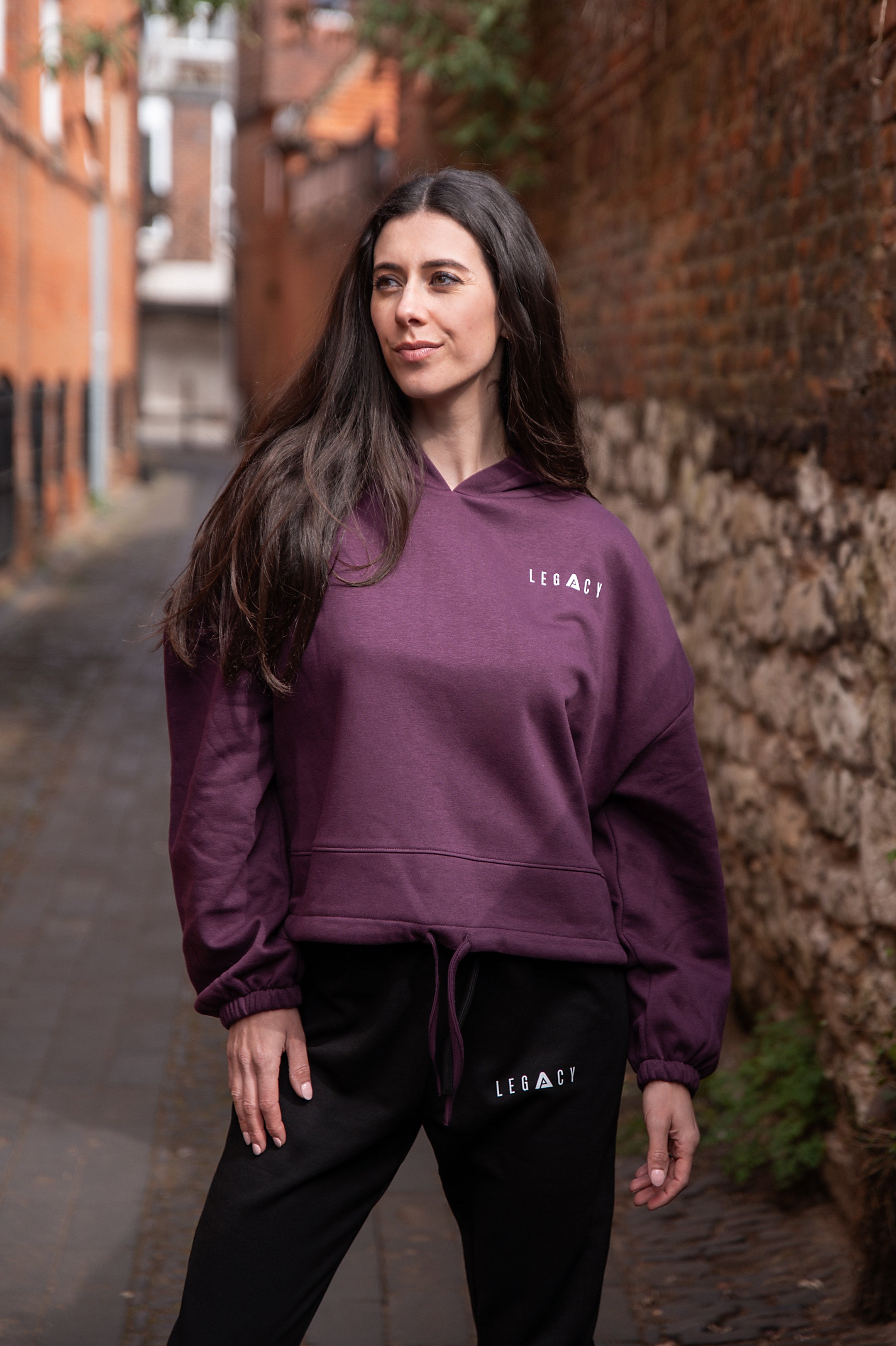 Women's burgundy oversized crop hoodie with tie waist and small white logo.