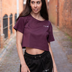 Women's burgundy crop t-shirt with white logo.
