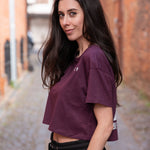 Women's burgundy crop t-shirt with white logo.