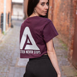 Back view of women's burgundy crop t-shirt with white Better Never Stops logo.