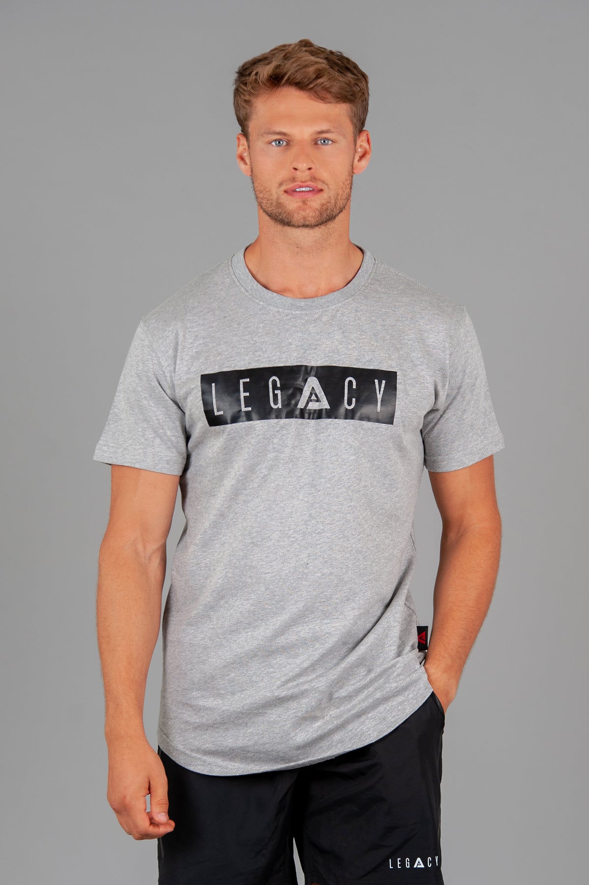 Men's grey t-shirt with black boxed Legacy logo across chest. 