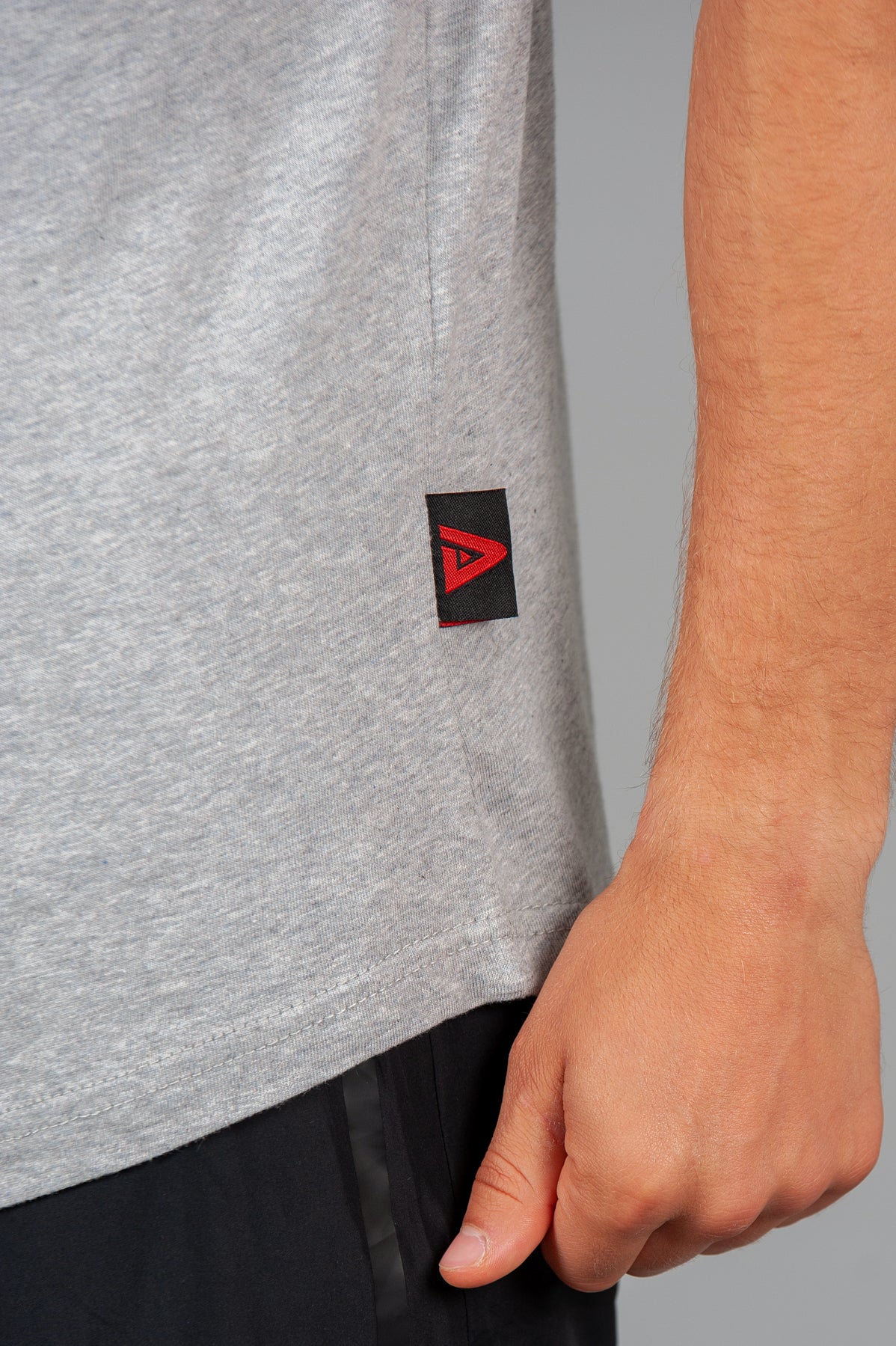 Close up of Legacy tag on men's grey tank.