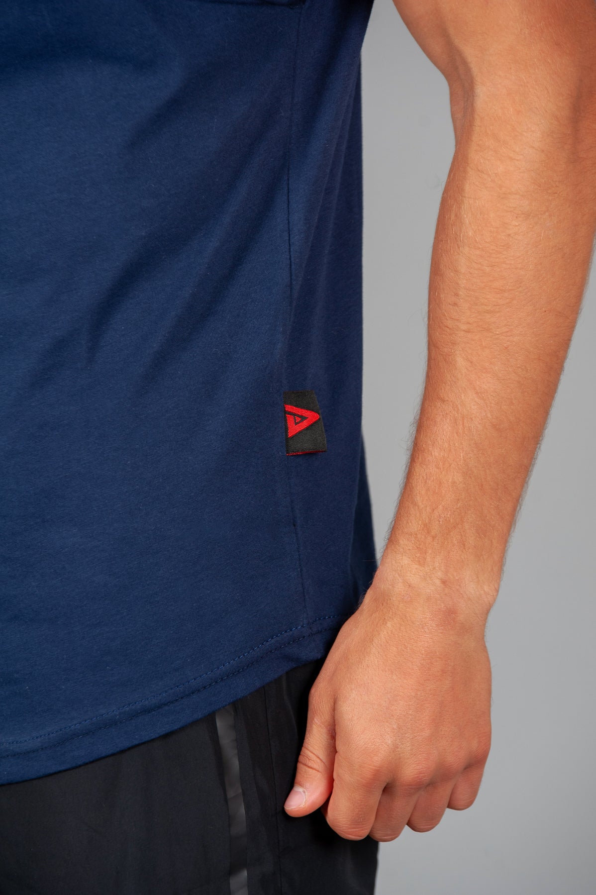 Close up of Legacy tag on men's navy tank.