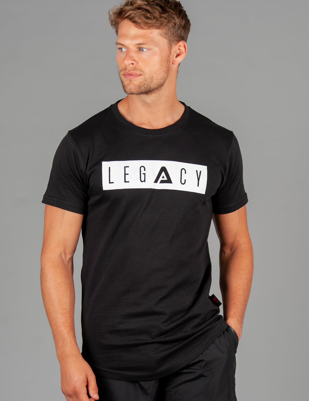 Men's black t-shirt with white boxed Legacy logo across chest. 
