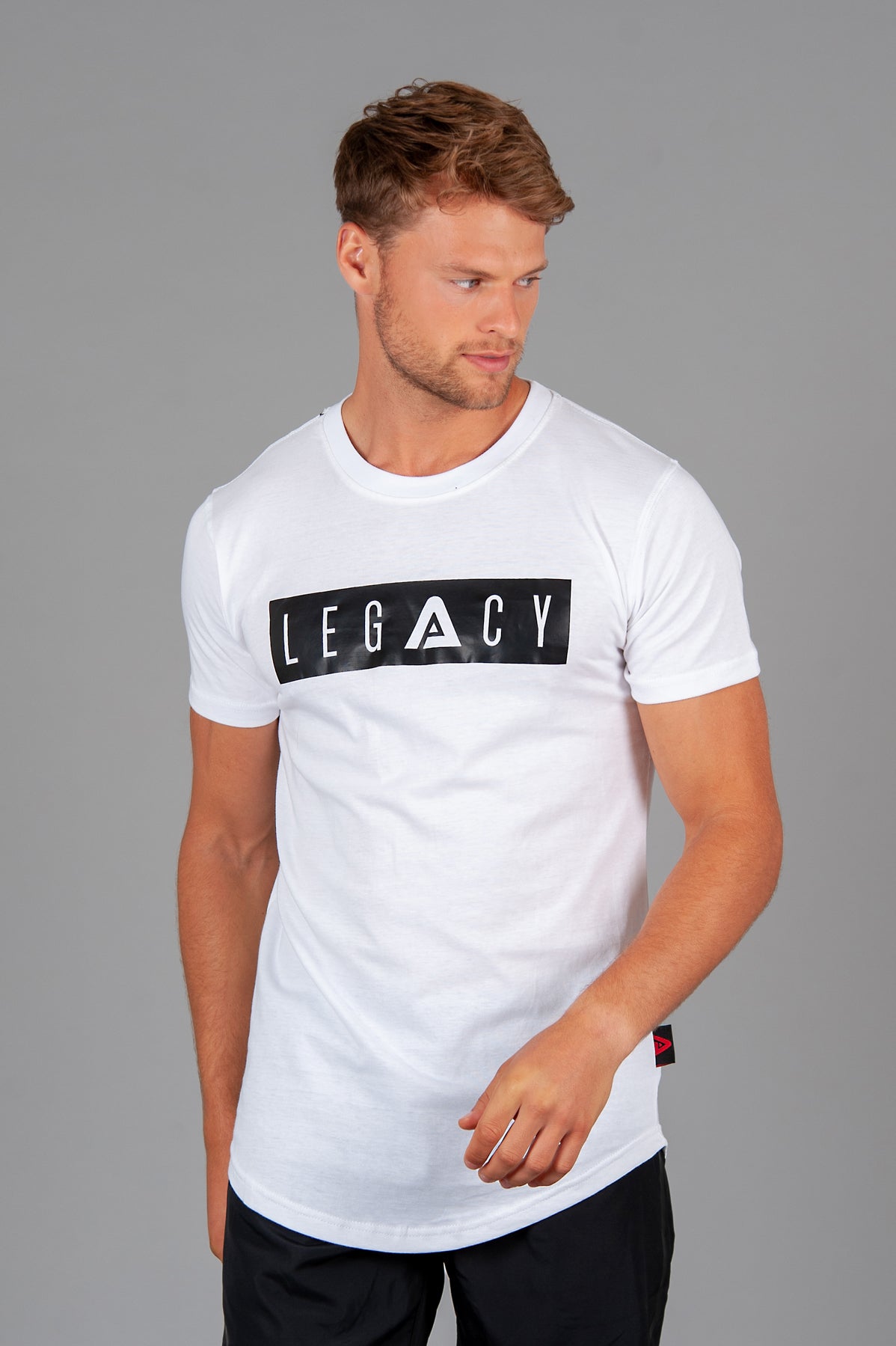 Men's white t-shirt with black boxed Legacy logo across chest. 