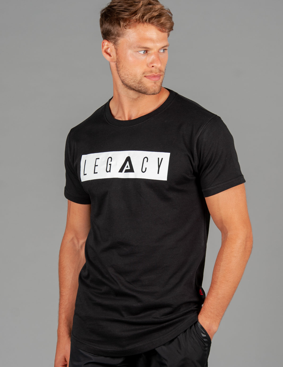 Men's black t-shirt with white boxed Legacy logo across chest. 
