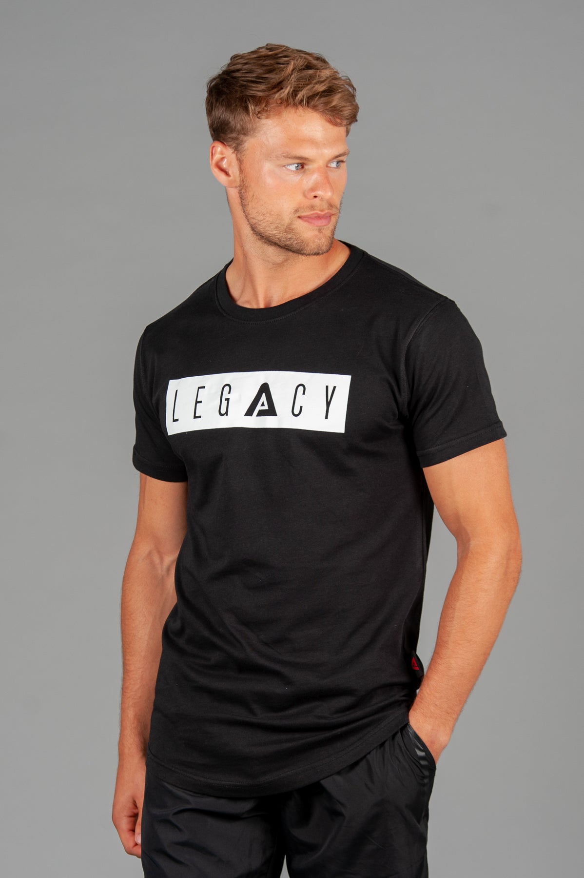 Men's black t-shirt with white boxed Legacy logo across chest. 