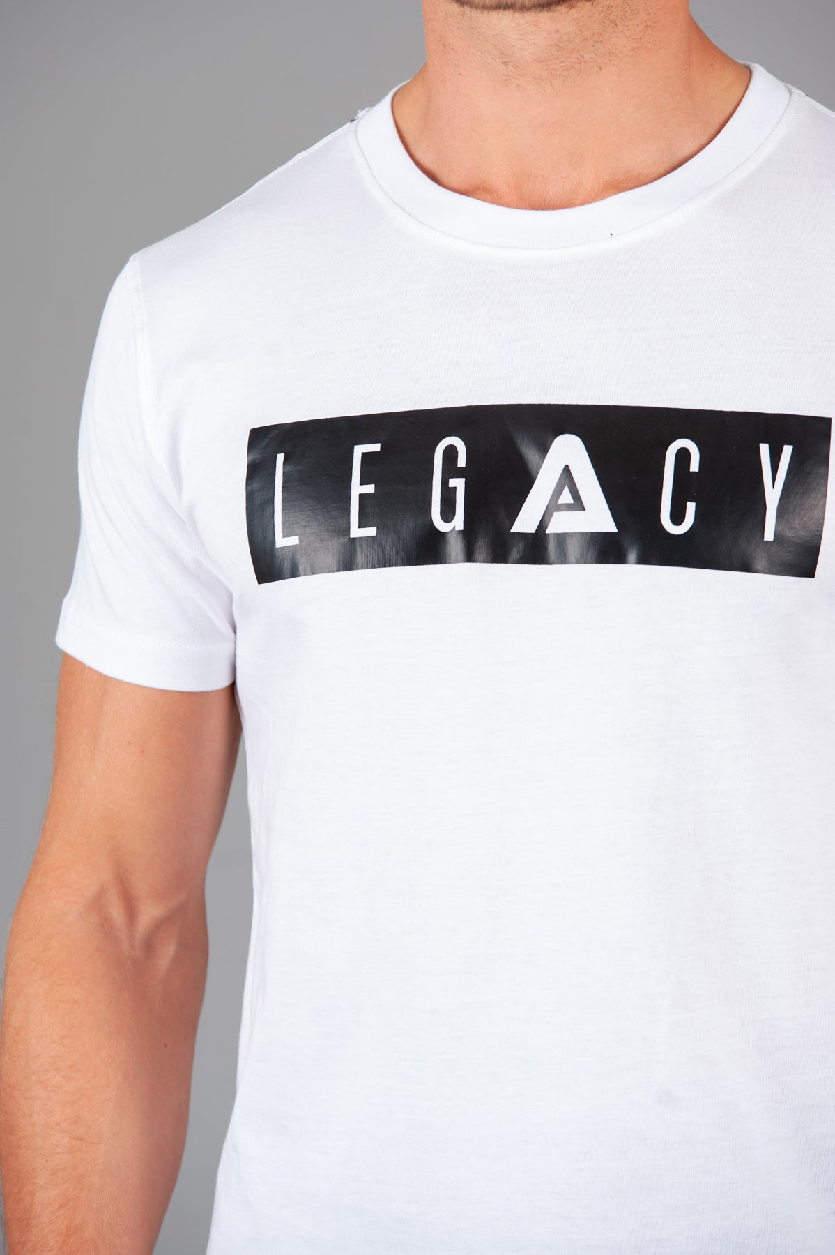 Men's white t-shirt with black boxed Legacy logo across chest. 