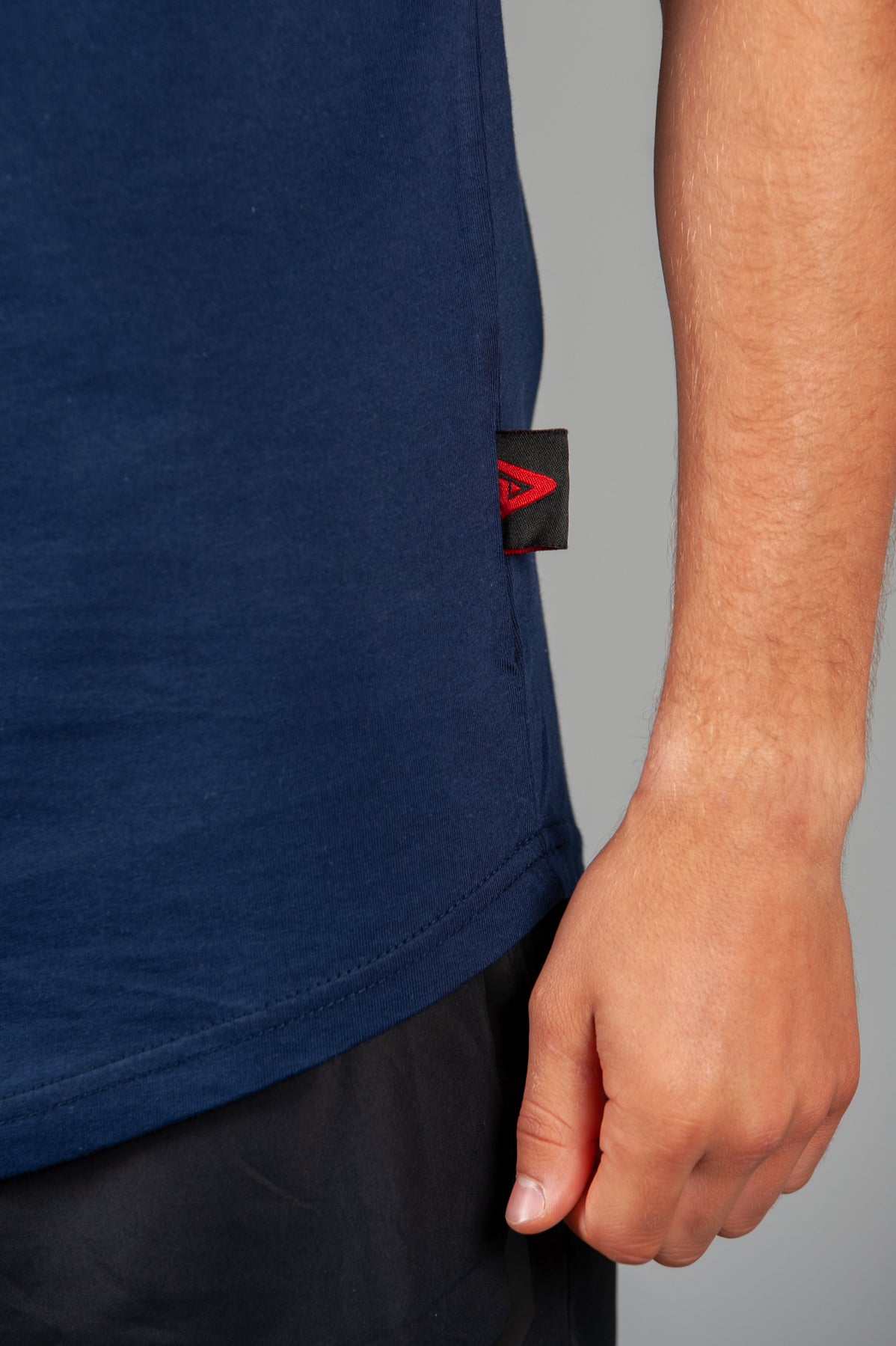 Close up of Legacy tag on men's navy t-shirt.