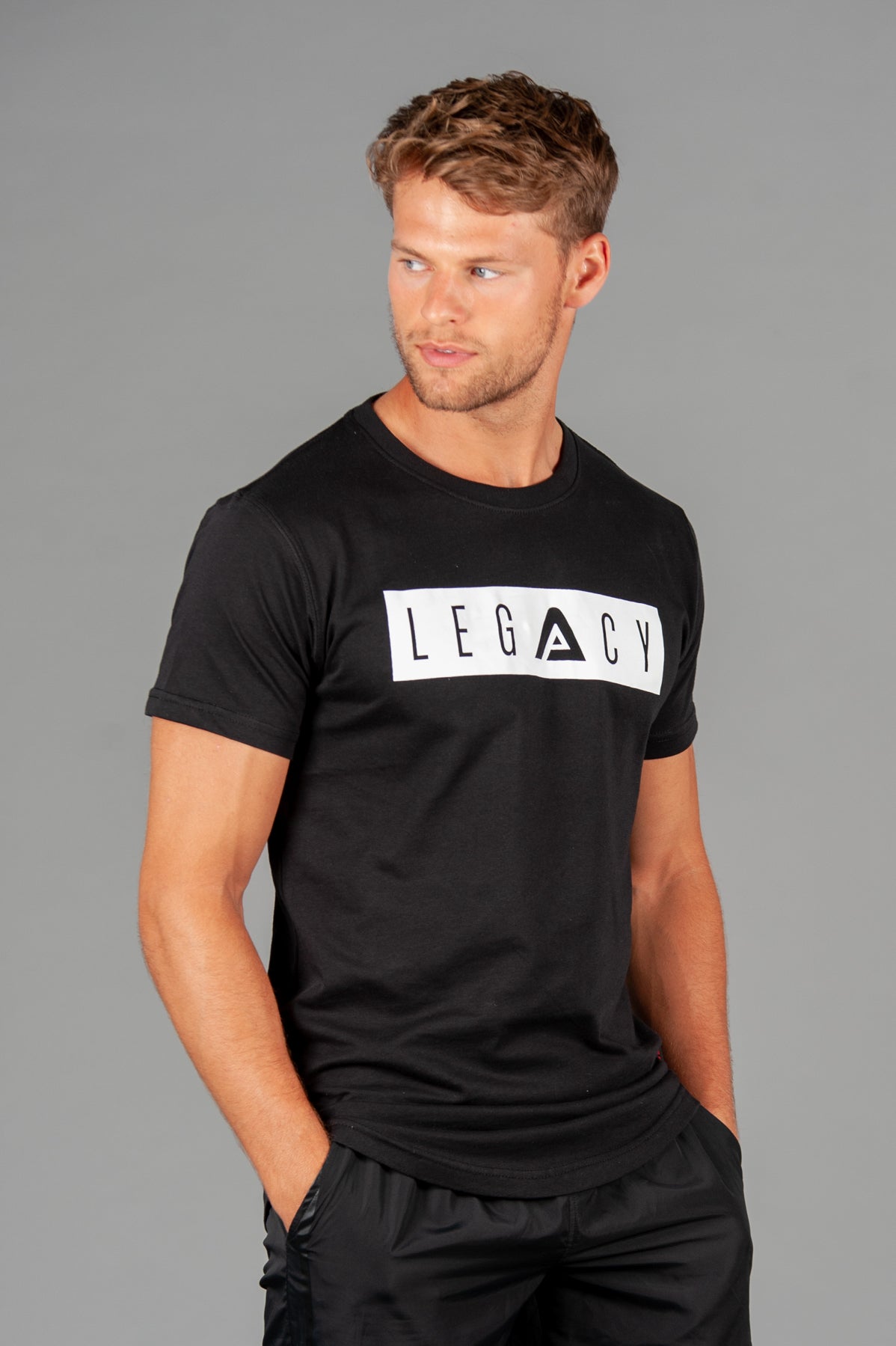 Men's black t-shirt with white boxed Legacy logo across chest. 