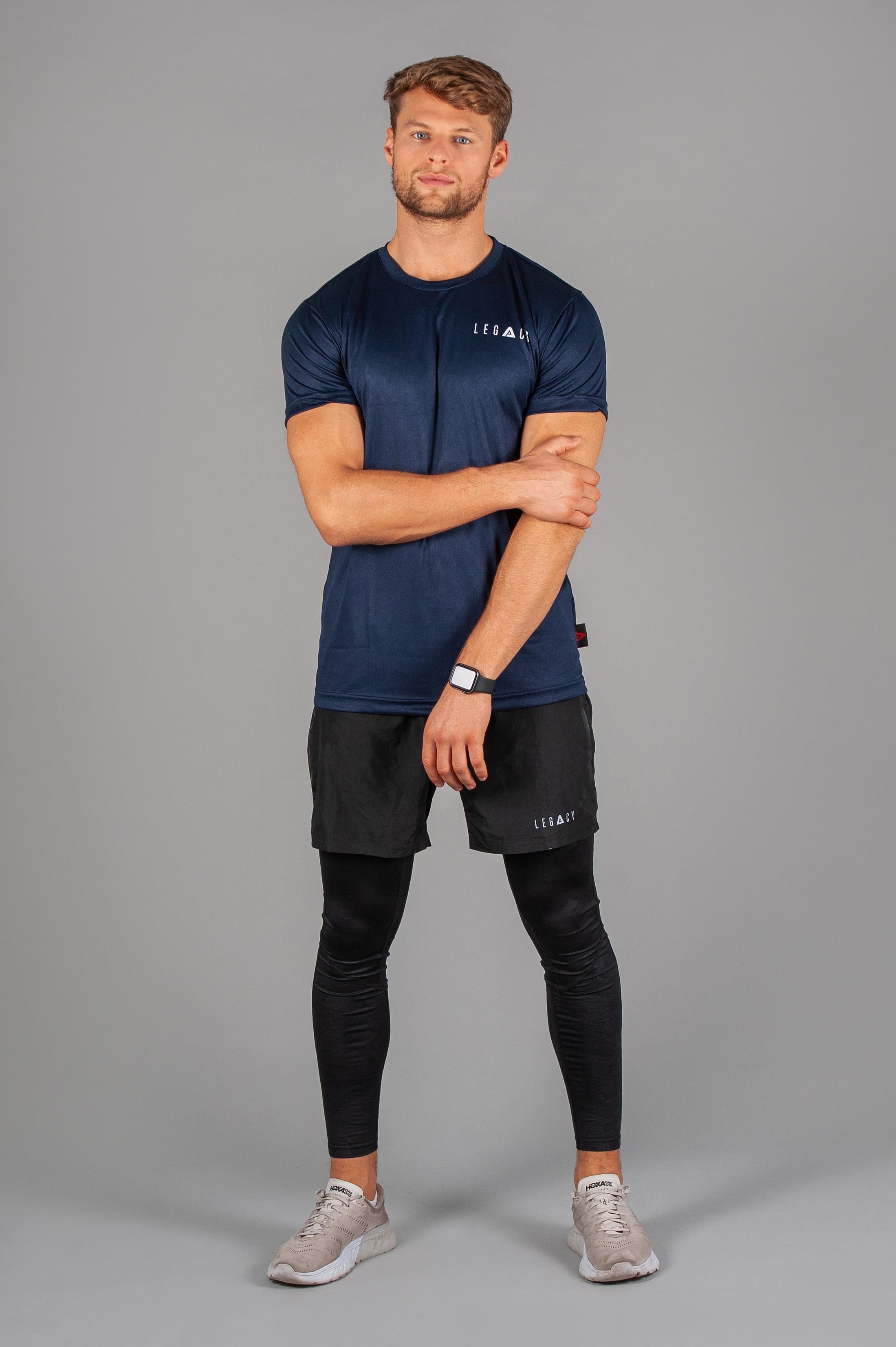 Men's navy moisture wicking crewneck t-shirt with white logo.