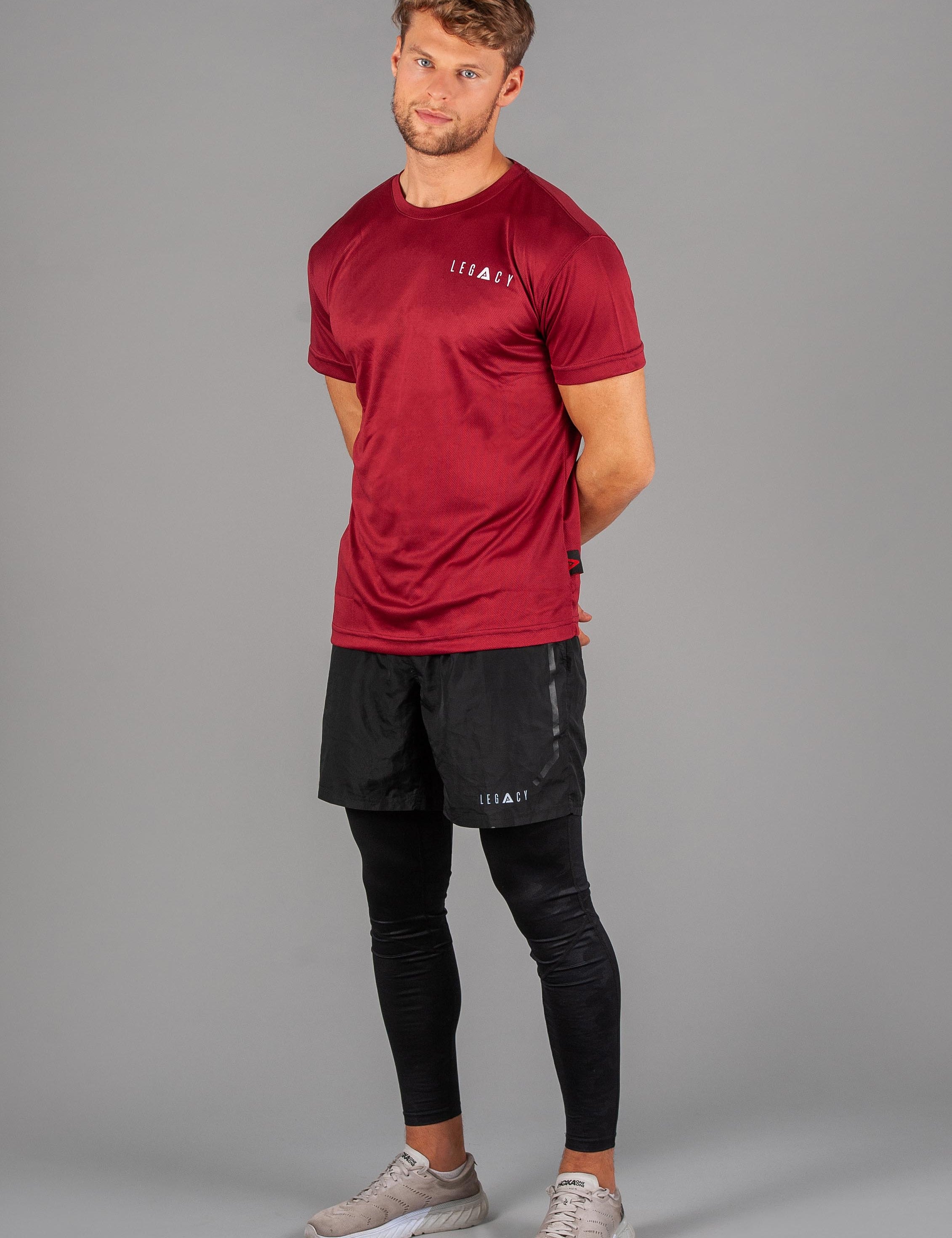 Men's burgundy moisture wicking crewneck t-shirt with white logo.