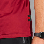 Close up of men's burgundy moisture wicking crewneck t-shirt fabric. 