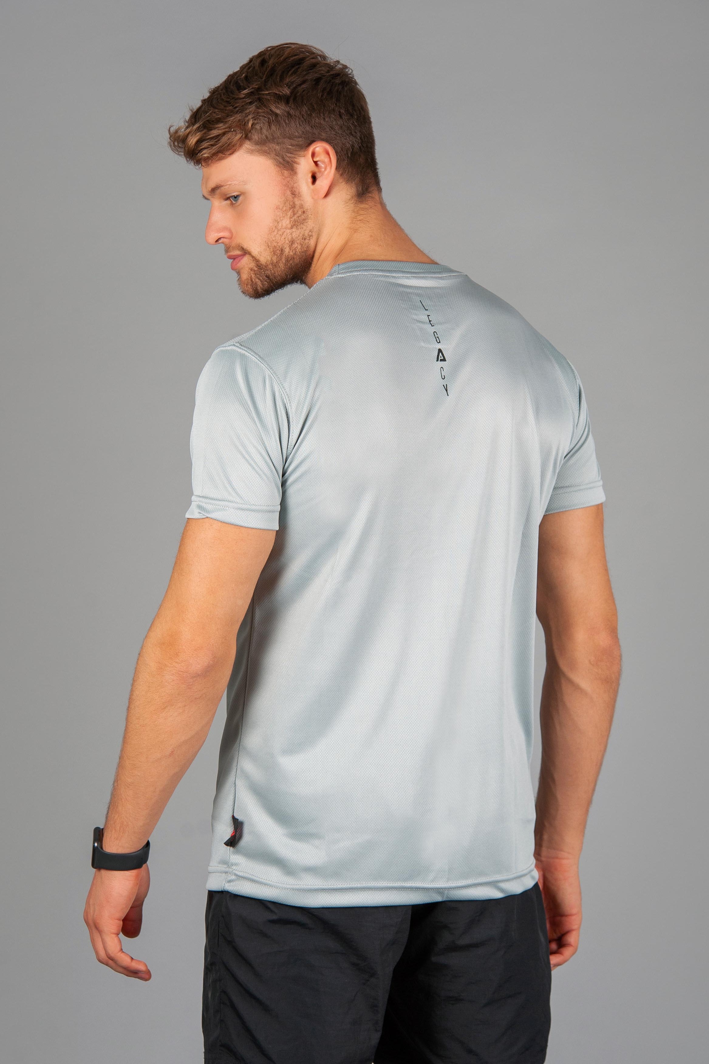 Back view of men's silver moisture wicking crewneck t-shirt with black logo.