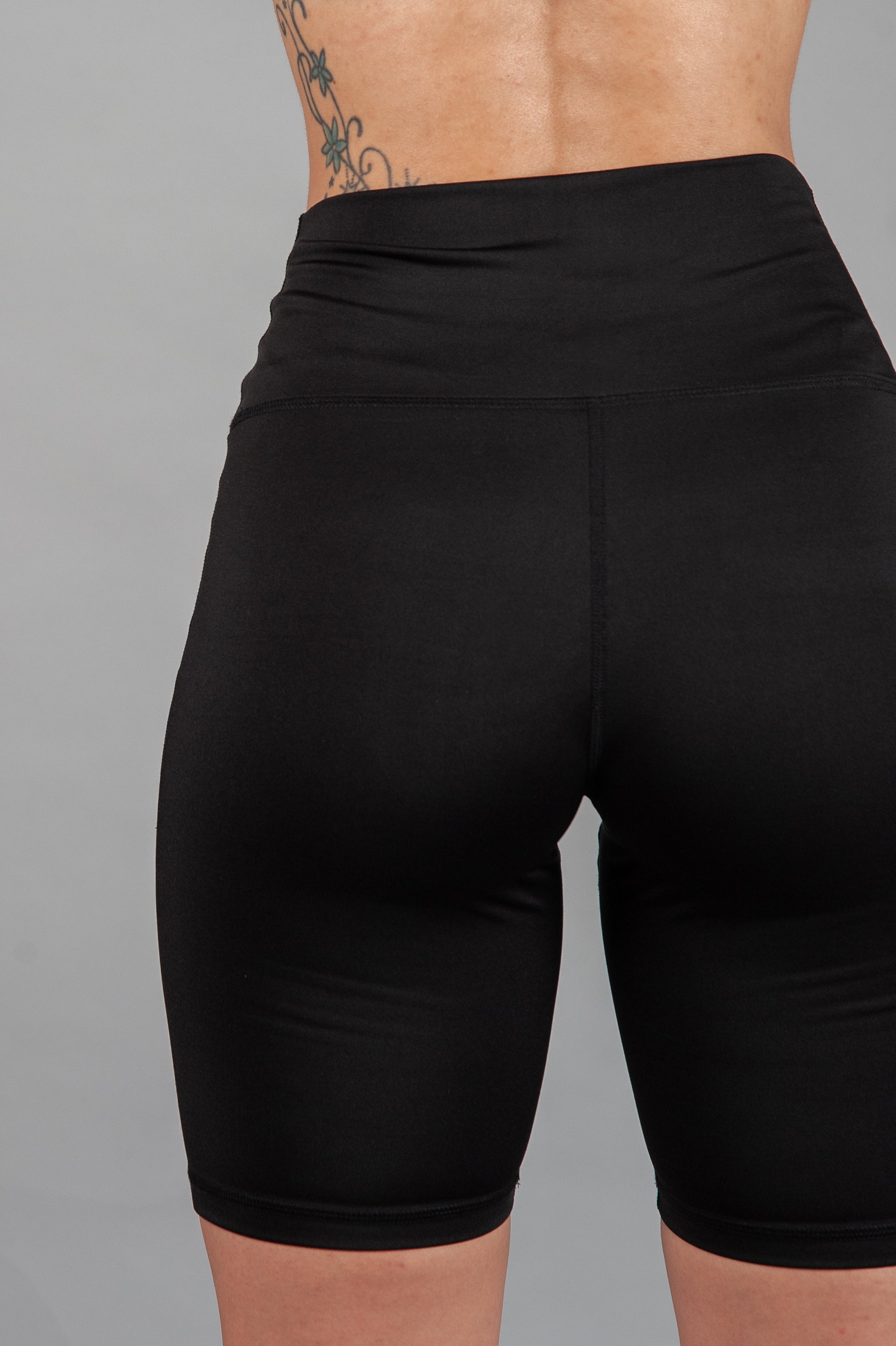 Back view of women's black bike shorts. 