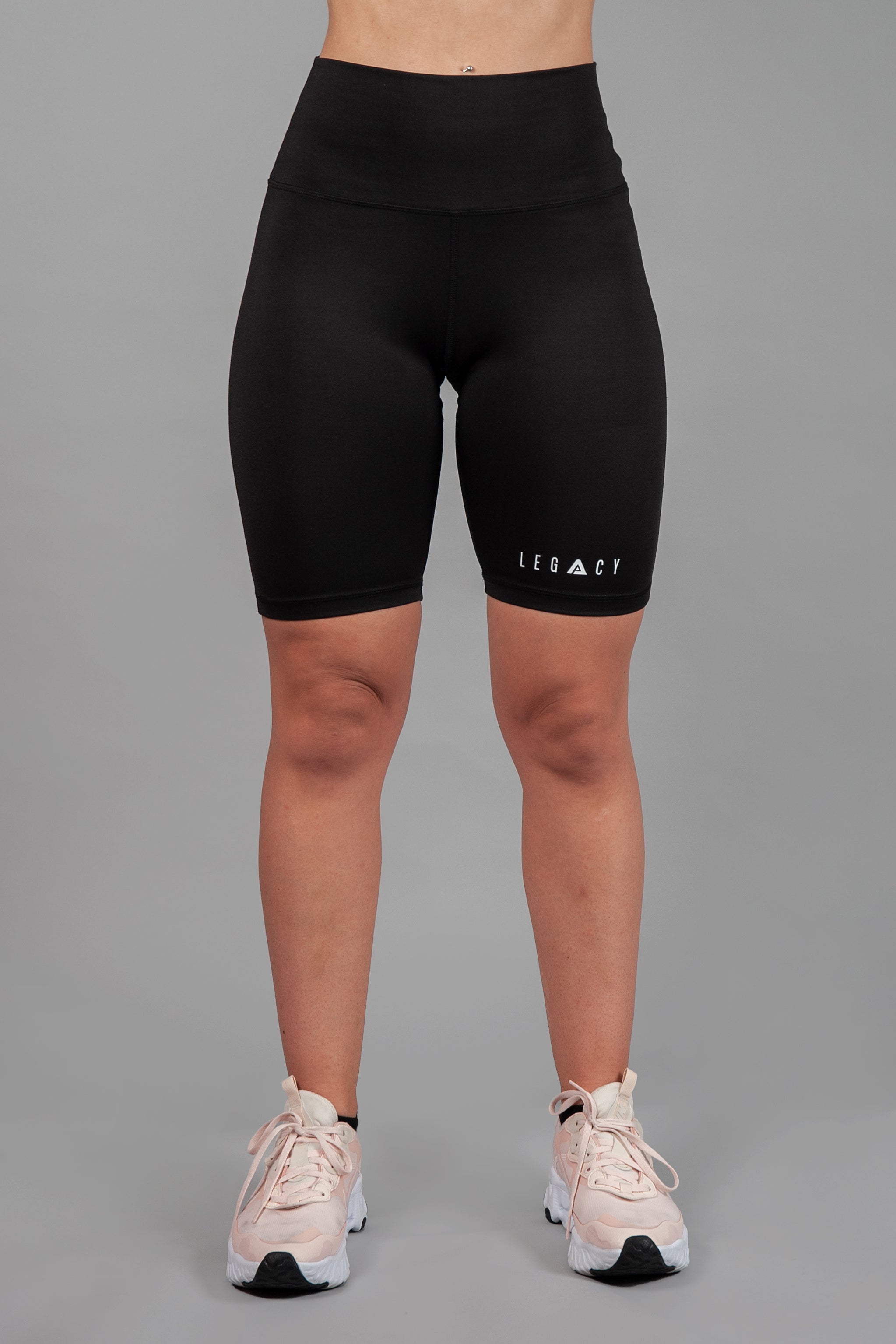 Women's black bike shorts with small white Legacy logo on the leg. 