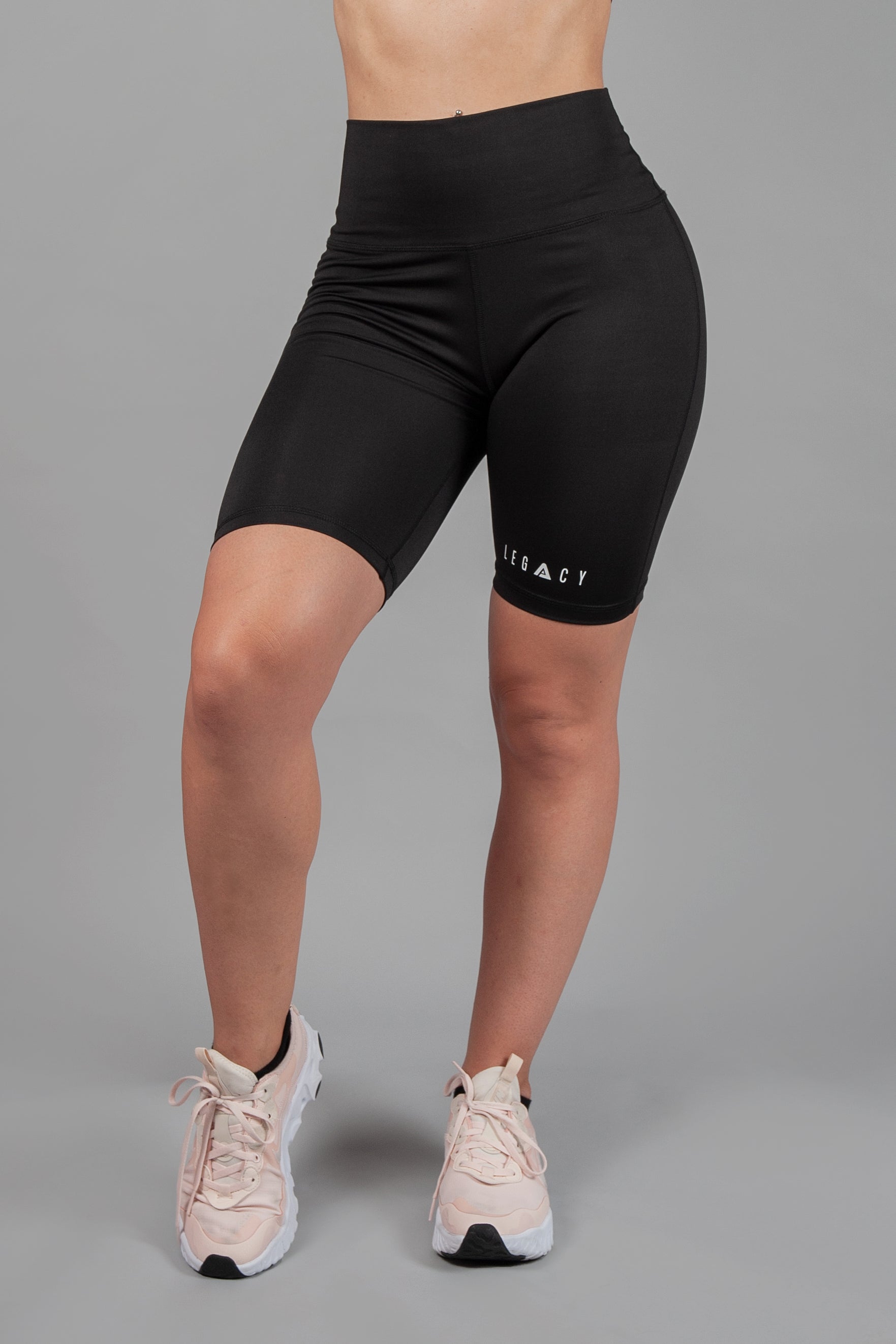Women's black bike shorts with small white Legacy logo on the leg. 