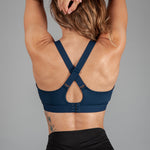 Back view of women's navy sports bra with cross-over adjustable straps and clasp back.