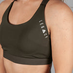 Women's olive sports bra with white Legacy logo on the side.