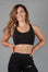 Women's black sports bra with white Legacy logo on the side.